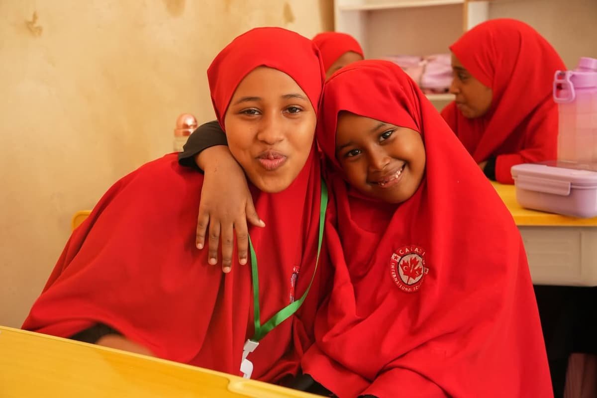 Illustration: Two students smiling together in class